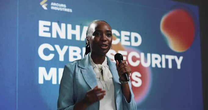 Conference, presentation and black woman with cyber security, speaker and software update. African person, speech or presenter in seminar, mic or progress for tech, about us or expert with solution