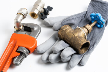 Plumbing tools and gloves on white background. Accessories for plumbing work.