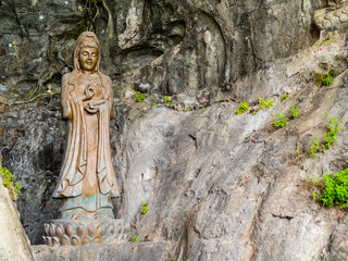 Impressive stone Buddha statues carved at the entrance of Fubo Hill cave, Guilin, China