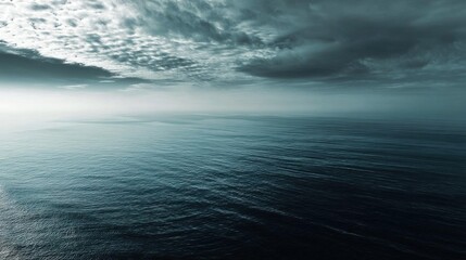 Fototapeta premium Calm sea with soft clouds in the sky, peaceful ocean atmosphere.