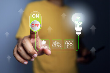 World environment day concept with hand turn off switch to reduce electric energy power consumption...