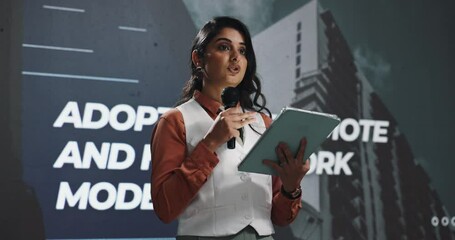 Woman, mic and tablet for speech at conference for remote, hybrid and seminar for work change. Speaker, digital and talking on stage with information, company growth and transformation of development