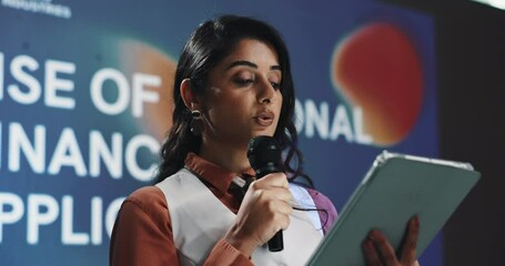 Business woman, conference and speech with tablet for rise of personal financial applications. Speaker, microphone and technology at finance seminar, investment expo and money management presentation