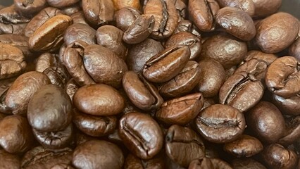 coffee beans background close up of roasted coffee beans . brown