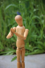 Wooden man in prayer