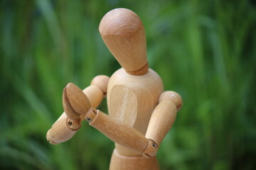 Wooden man with hands praying