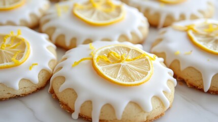 Lemon iced cookies decorated with royal icing and a lemon zest garnish on top.