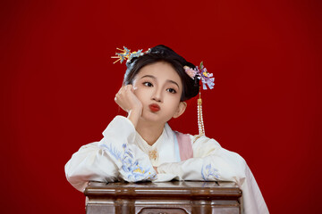 Girl wearing Chinese Ming Dynasty Hanfu costume against a red background