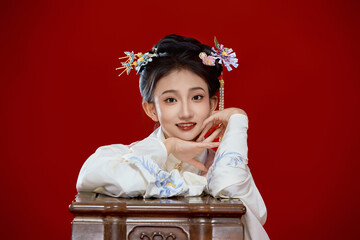Girl wearing Chinese Ming Dynasty Hanfu costume against a red background