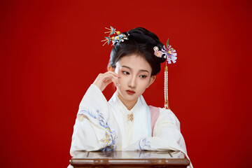 Girl wearing Chinese Ming Dynasty Hanfu costume against a red background