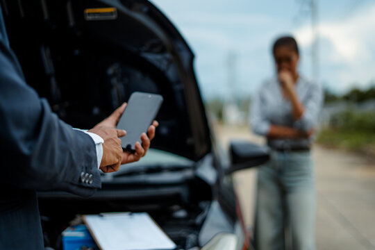 asian woman customer and mechanic discussing car insurance. female manager and car mechanic. car repair and maintenance concept.