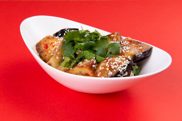 Fried eggplants with herbs in a plate.