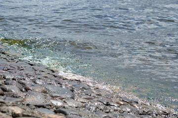 stone embankment of the river and water