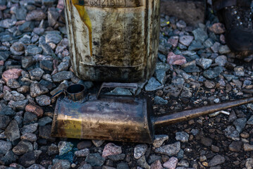 A metal watering can (oil can) for pouring grease into various mechanisms and systems of the locomotive and a metal canister. 
