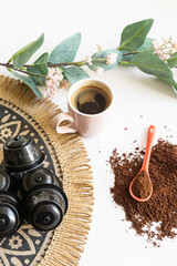 Comparing ground coffee and coffee Ppods with freshly brewed espresso. Vertical shot.