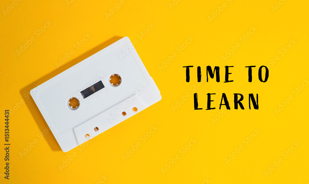 Poster white cassette tape is on a yellow background with the words time to learn
