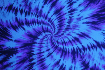 Abstract tie dye spiral pattern in blue and purple hues