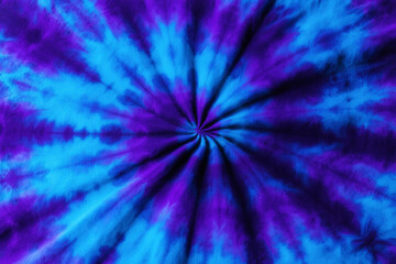 Vibrant tie dye pattern with blue and purple spiral design