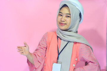 Worker woman wearing safety vest and project helmet on isolated background