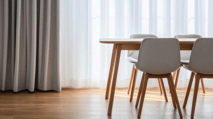 Wooden dining table and chairs in a bright room.