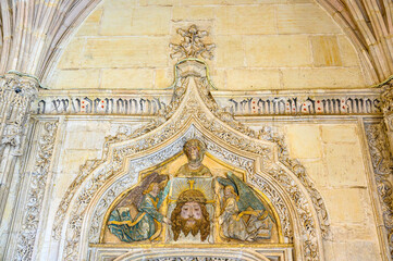 Stone wall with decorative religious art inside the Monastery of San Juan de los Reyes, Toledo, Spain.