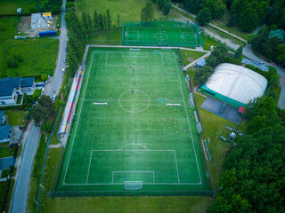 View from above of the all-season football pitch with players.
