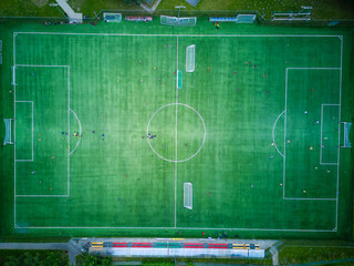 View from above of the all-season football pitch with players.
