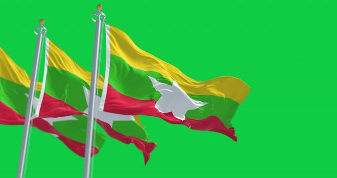 Myanmar national flags waving in the wind isolated on green background