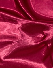 Obraz premium Dark red glossy silk cloth texture close view background