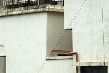 A minimalistic building features a combination of textured surfaces and straight lines, showcasing...