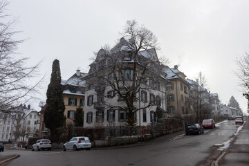 A charming residential street scene in St. Gallen, Switzerland, showcasing traditional multi-story...