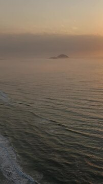 Florianopolis in Santa Catarina during a wonderful sunrise. Mo&ccedil;ambique Beach in aerial view, vertical video.