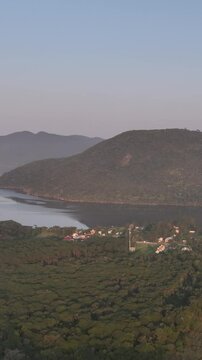 Florianopolis in Santa Catarina during a wonderful sunrise. Mo&ccedil;ambique Beach in aerial view, vertical video.