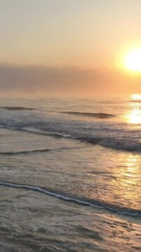 Florianopolis in Santa Catarina during a wonderful sunrise. Mo&ccedil;ambique Beach in aerial view, vertical video.