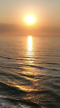 Florianopolis in Santa Catarina during a wonderful sunrise. Mo&ccedil;ambique Beach in aerial view, vertical video.