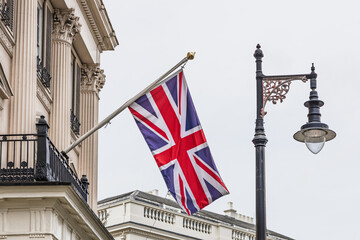 British Union Jack Flag Flying Outside Classical London Building with Street Lantern