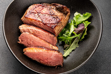 Duck breast roast meat poultry fresh delicious gourmet food background on the table rustic food top view copy space