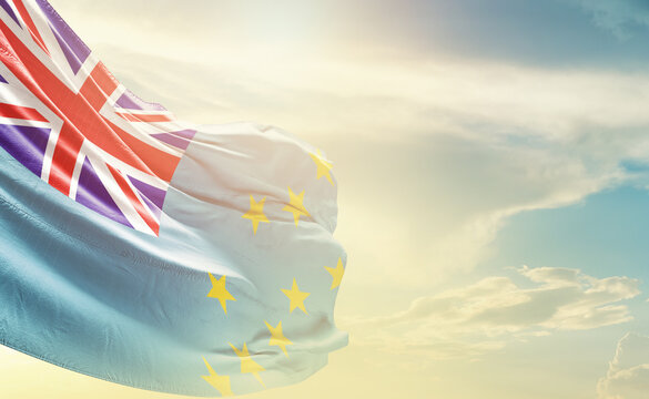 Tuvalu flag wave in soft clouds. National flag beautifully waving in the sky. Tuvalu national flag for independence day.