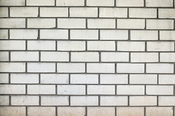 White brick wall, background. Light dirty brick, fence. Close-up of white brick exterior wall. Construction, building, close-up of house element