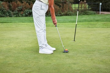 Legs, sports and person with club on golf course, ready for swing and exercise outdoor for...