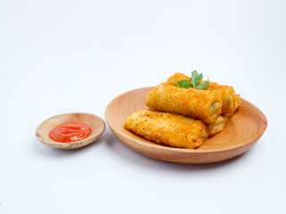 Crispy Indonesian risol mayo rolls served on a wooden plate with chili sauce in a small bowl, isolated on a white background