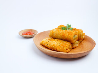 Crispy Indonesian risol mayo rolls served on a wooden plate with chili sauce in a small bowl, isolated on a white background
