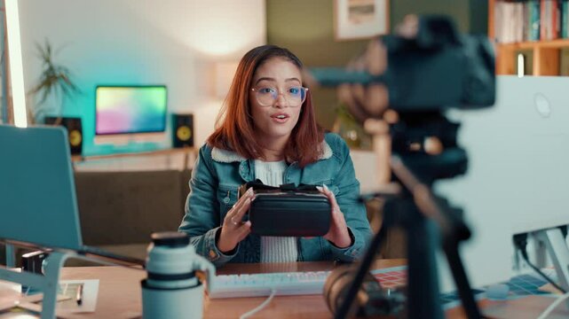 Recording, social media and vr headset with influencer woman in home studio for broadcast. Live streaming, tech and video with content creator at desk in apartment for product promotion or review