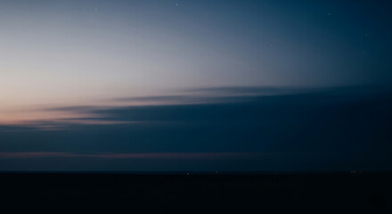 Fototapeta premium Tranquil Twilight Sky Background with Fading Blue Hues and Distant Horizon, Capturing the Peaceful Transition from Day to Night in a Natural Landscape