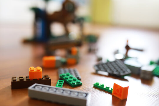 Colorful Assorted LEGO Blocks on Wooden Surface with Blurred Background