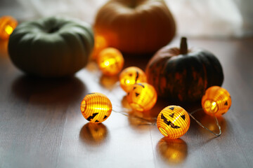 Halloween Pumpkins and Jack-O'-Lantern String Lights Decoration on Wooden Surface