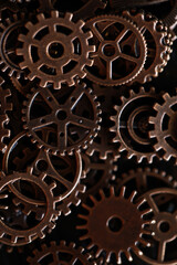 Close-Up of Interlocking Vintage Bronze Gears and Cogs in Dark Environment