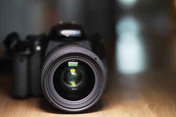 Close-up Lens Focus on Professional DSLR Camera on Wooden Surface
