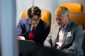 Business trip vacation and travel concept. Caucasian business Man travelling by plane and working...