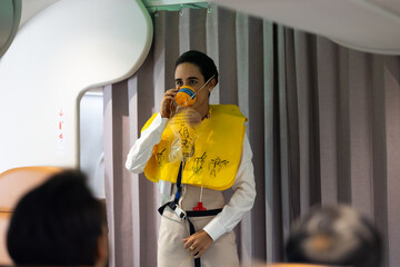 in-flight safety demonstration : Air hostess staff airline demonstrate. Cabin Crew or Steward staff airline demonstrate safety procedures to passengers. Flight attendant